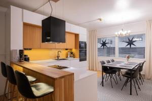 a kitchen and dining room with a table and chairs at Northern Lights River in Rovaniemi