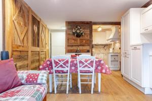 a kitchen with a table and chairs in a room at Cervino View, Ski-In and WiFi! in Breuil-Cervinia