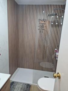 a bathroom with a shower with a toilet at El Rinconcito Mágico in El Bosque +40 photos