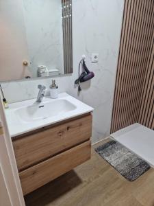 a bathroom with a sink and a mirror at El Rinconcito Mágico in El Bosque
