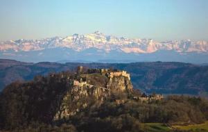 a castle on top of a mountain with mountains at Schöne Ferienwohnung Bodenseeregion in Singen