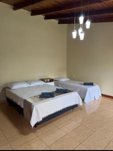 a bedroom with two beds and a ceiling at Quinta "La Calma" in Puerto Iguazú +2 photos