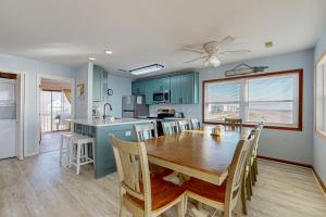 a kitchen and dining room with a table and chairs at OIB28 Summer Sands in Ocean Isle Beach