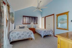 a bedroom with two beds and a ceiling fan at OIB28 Summer Sands in Ocean Isle Beach