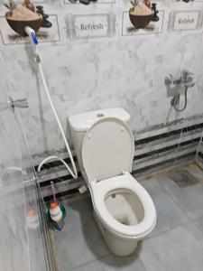 a bathroom with a white toilet in a room at فندق الإيمان El Eman Hotel in Maḩaţţat Idfū +34 photos