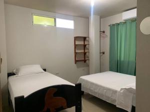 a bedroom with two beds and a window at Casa Brankonrald in San Cristóbal +12 photos