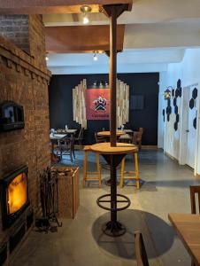 a restaurant with tables and chairs and a fireplace at Auberge Carcajou in Saint-David-de-Falardeau