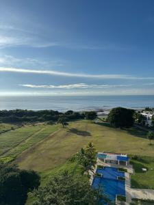 an aerial view of a house and the ocean at Apartamento Frente al Mar en Río Hato, Playa Blan ca, Piscina y Acceso Directo a la Playa in Playa Blanca