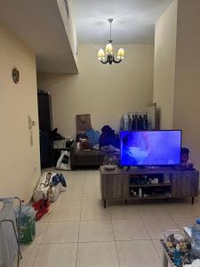a living room with a flat screen tv on a table at 1BHK Furnished Apartment in Dubai