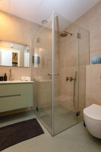 a bathroom with a shower and a toilet and a sink at Luxury Garden Studio Apartment 3 in Tel Aviv