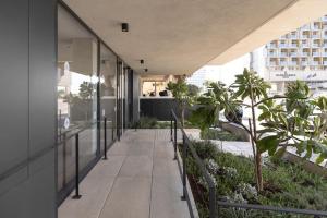 an open hallway of a building with palm trees on it at Luxury Garden Studio Apartment 2 in Tel Aviv