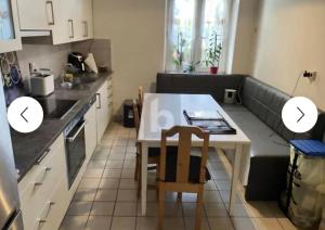 a small kitchen with a small table and a table and chairs at apartament N-R in Röthenbach an der Pegnitz
