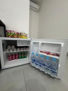 an open refrigerator with bottles of water in it at Pousada Parque do Lago in Sinop
