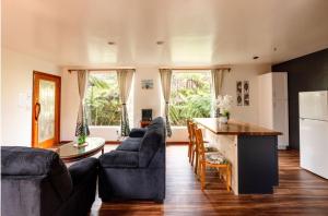 a living room with a couch and a table at Caldera- Hale Kumu La'au at Volcano in Volcano