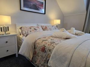 a bedroom with two beds and a nightstand with two lamps at Dreams and Homes in Dublin- Entire home in Hartstown