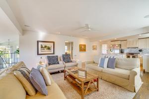 a living room with two couches and a table at 1 Mi to Dtwn Fayetteville Home with Fenced Yard in Fayetteville