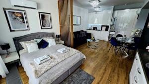 a bedroom with a bed and a table in a room at Crystal Baltic 222 in Dziwnówek