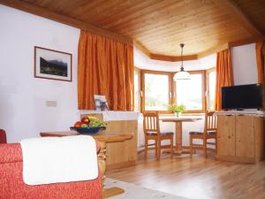 a living room with a table and a dining room at Neunerhof in Leutasch +22 photos