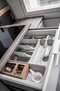 a drawer filled with utensils in a refrigerator at Apartment Siihtala - suuri saunallinen huoneisto in Joensuu