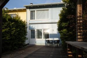 a house with two chairs and a table in front of it at Apartment Siihtala - suuri saunallinen huoneisto in Joensuu