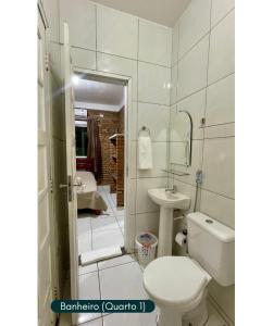 a bathroom with a toilet and a sink and a shower at Condomínio Chalés Santo Antônio - Flecheiras in Trairi