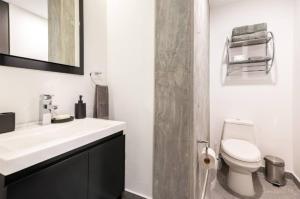 ein weißes Badezimmer mit Waschbecken und Toilette in der Unterkunft CH604 1-1BR 1 BTH Deluxe in Mexiko-Stadt + 2 Fotos