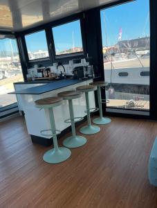 多尔梅莱托HouseBoat - Lago Maggiore con Jacuzzi的厨房设有2张凳子和1个带窗户的柜台。