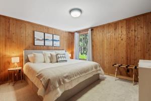 a bedroom with a large bed and wooden walls at Shanty Creek, Golf, Families, Vacation, Pool Pass in Bellaire
