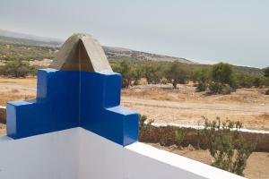 a blue cross on top of a white wall at Lair De La Mer Resort Hotel in Sidi Kaouki