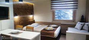 a living room with a couch and a table at Apartment Dream Konaci in Kopaonik