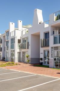 an empty parking lot in front of a building at Caline-V Luxury beach Front Flat in Cape Town