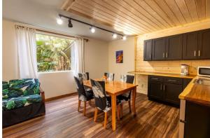 a kitchen and dining room with a table and chairs at Halema'uma'u- Hale Kumu La'au in Volcano