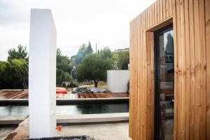 a wooden house with a view of the water at 4u Bed & Spa in Opoul-Périllos