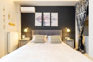 a bedroom with a large white bed with two pillows at Diamond apartment in Athens