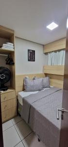 a bedroom with a bed and a clock on the wall at Beautiful Beachclass in Fortaleza +24 photos