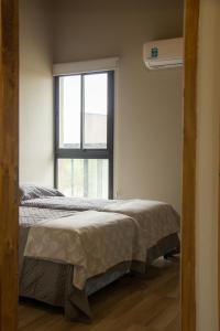 a bedroom with two beds and a window at Blend Lodges in Tunuyán