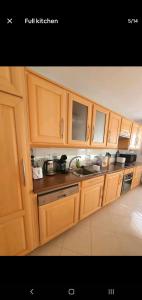 a kitchen with wooden cabinets and a sink at Renewed Spacious 35m2 Studio in Paris in Paris +8 photos