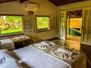 Cama ou camas em um quarto em Chalé Varandas Vistamar com Ar Condicionado e churrasqueira