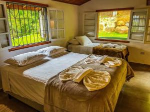 Cama ou camas em um quarto em Chalé Varandas Vistamar com Ar Condicionado e churrasqueira