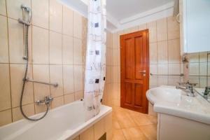 a bathroom with a shower and a tub and a sink at Apartments Vladimir in Malinska +50 photos