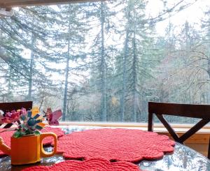 a table with a coffee mug on a table in front of a window at The Mountain House in Corvallis