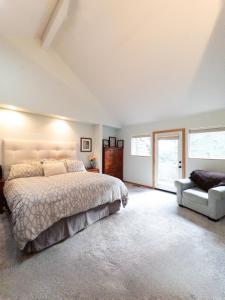a bedroom with a large bed and a chair at The Mountain House in Corvallis +38 photos