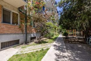 an empty sidewalk in front of a building at Katos home in Tbilisi City