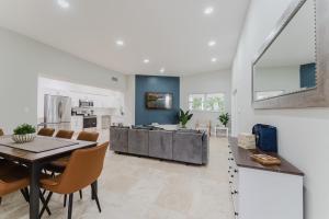 a kitchen and dining room with a table and chairs at Beautiful Aventura Villa Sleeps 26 in Miami
