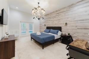 a bedroom with a blue bed and a wooden wall at Beautiful Aventura Villa Sleeps 26 in Miami +70 photos