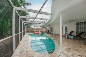 an indoor swimming pool with a glass roof at Beautiful Aventura Villa Sleeps 26 in Miami