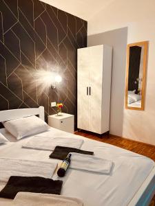 a bedroom with a bed with a bottle of wine on it at Dado in Virpazar +20 photos