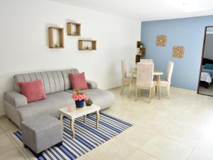a living room with a couch and a table at Hotel Iguaraya Inn in Ríohacha