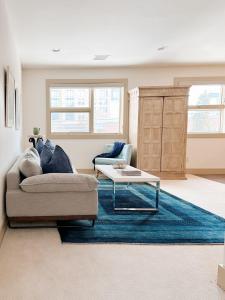 a living room with a couch and a coffee table at 1 bed apartment with parking - Denver Museum District Walk to Convention Center, Capital, museums and shops in Denver
