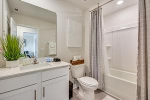 a bathroom with a toilet and a sink and a shower at Modern Townhome with Private Yard in Kernersville! in Kernersville +17 photos